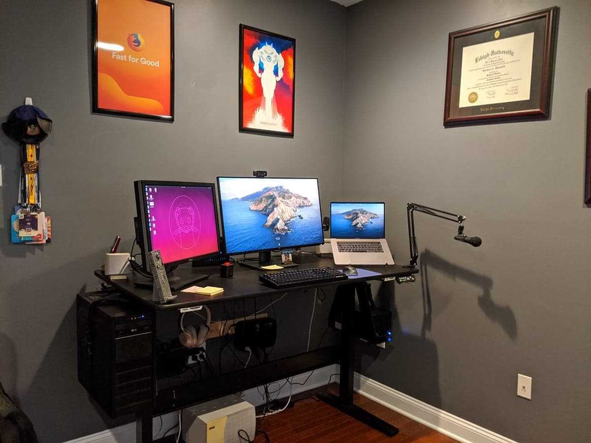 A height-adjustable standing desk set up in a home office