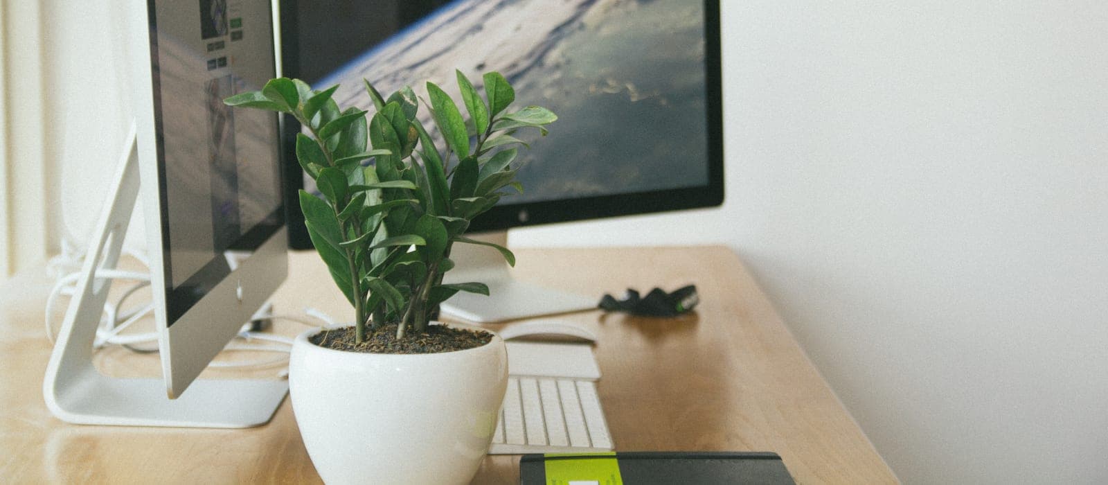A desktop standing desk converter above a conventional desk