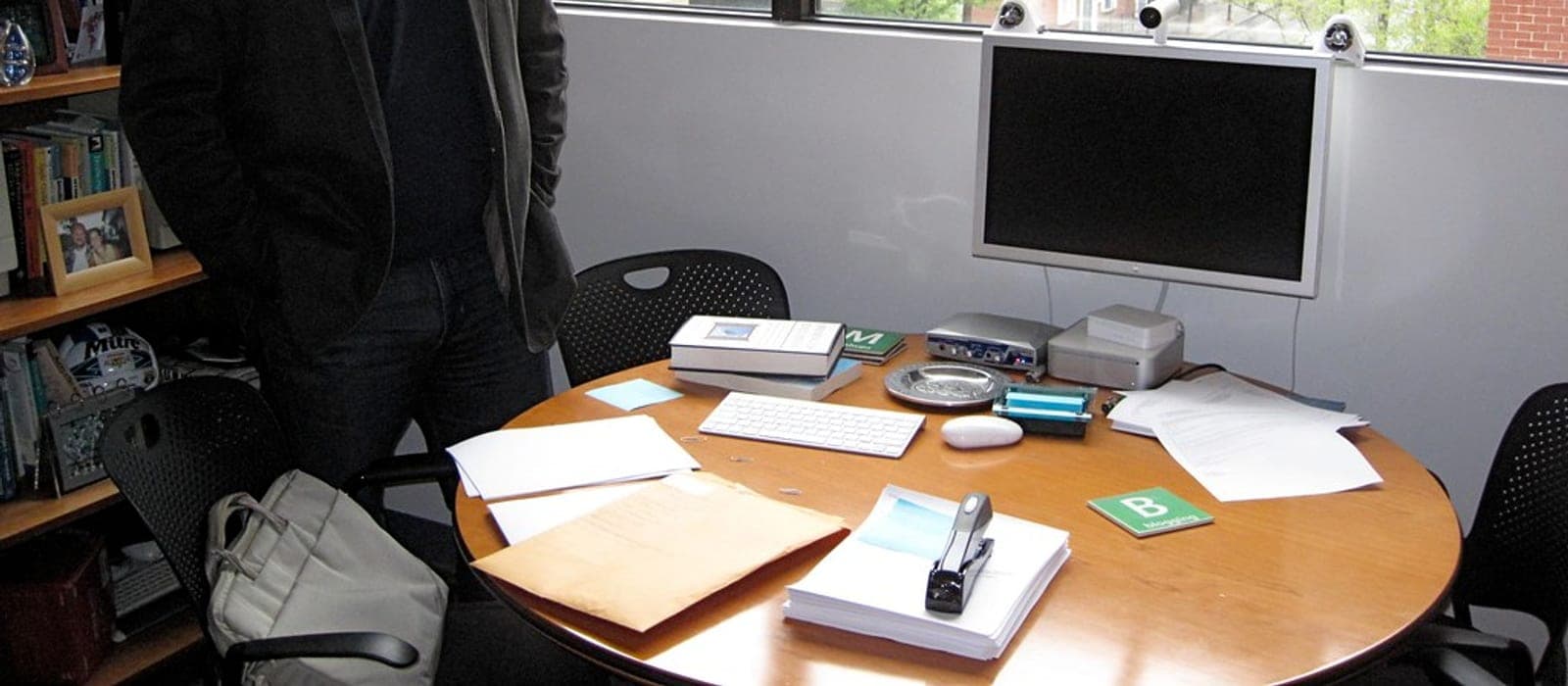 A height-adjustable sit-stand desk in a home office